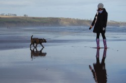 Gemma and Teabag with reflection on the beach at Lunan Bay