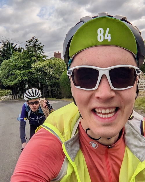A selfie with Piper, followed by Richard with breakfast wrap in his face, while riding Sunday morning at All Points North 2023